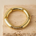 Polished gold elastic bracelet featuring curved tube links on a natural stone background - Polished Metallic Gold (AB0077-6)
