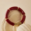 Macro detail of amber resin beaded bracelet with gold accents on marble stone - Deep Red Amber (AB0077-5)