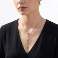 Golden multi-layer necklace featuring seven vertical multi-color gemstones worn by model - Colorful Zirconia Gold