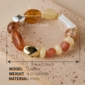 Detailed view of irregular acrylic beads in amber and cream on a vintage beach style bracelet - AB0094-7