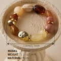 Macro shot of irregular acrylic beads in amber and pink with gold metal spacer rings - AB0094-9