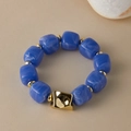 Detail of blue acrylic beads and gold geometric accents on an irregular chunky bracelet - Random Texture/Shade / Blue Texture (AB0075-15)