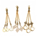 Close-up of golden alloy Tasbih tassel pendants with moon and star charms for prayer beads - Islamic Star Moon Style (PX18)