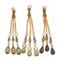 Close-up of three vintage gold alloy tassels with leaf and pineapple pendant details - Leaf Pineapple and Teardrop Style (PX16)