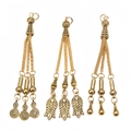 Detailed view of three vintage gold alloy tassels with intricate carved textures for jewelry DIY - Spiral Disc Leaf and Teardrop Style (PX15)