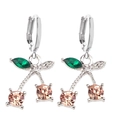Macro shot of cherry earrings with champagne zircons and green leaf crystal details - Silver Champagne