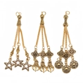 Detailed view of three vintage gold alloy tassels with ethnic patterns and star charms - Star and Sun Pattern Style (PX3)