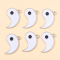 Detail of six white enamel Tai Chi Yin Yang pendants with silver edges for DIY jewelry - White Yin Yang Fish Style
