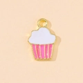 Detail of cupcake charm with pink and white enamel drip on a gold alloy metal base - Pink