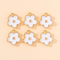 Detailed macro view of six white enamel cherry blossom flower charms for DIY jewelry making - White
