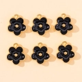 Detail view of six black enamel flower pendants with gold plating for DIY jewelry making - Black