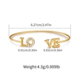 Macro shot of gold-plated open bangle with LOVE inscription and zircon details - LOVE Letter Inlaid Design (KB0528)