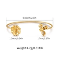 Macro detail of gold open bangle featuring bee and daisy motifs with cubic zirconia - Daisy and Bee Zirconia Design (KB0535)