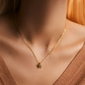 Golden starfish necklace with shimmering zircons worn by a model in a close-up view - 18K Gold / Starfish Shape Style (KN0315)