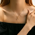 18K gold plated brass necklace with radial pendant and colorful gemstones on a model - Radial Colorful Stone Style (KN0251)