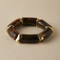 Detail of amber resin bracelet with marble texture and golden metal links on beige surface - Dark Brown Marble (AB0006-6)