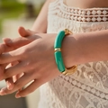 Detail showing bohemian beaded bracelet with green resin tubes and gold beads on wrist - Glossy Patchwork Style (AB0009-18) / Grass Green