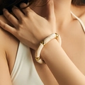 Detail of chunky acrylic marble effect bracelet with gold spacers on a female wrist - Cream Marble (AB0008-1)