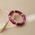Macro shot of purple marble resin bracelet beads with gold metal spacers on a stone - Purple Red Marble (AB0008-19)