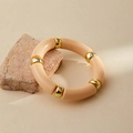 Detail of pink resin beaded bracelet with gold accents on a mineral stone backdrop - Light Pink Marble (AB0008-13)