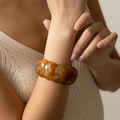 Close-up of amber marble acrylic block bracelet worn on wrist with beige knitwear - Amber Marble (AB0047-4)