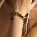 Detail of leopard print resin tube bracelet with golden spacers on a female wrist - Classic Leopard (AB0008-8)