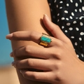 Bohemian gold textured wide ring featuring a rectangle turquoise stone on model's finger - Hammered Rectangle Turquoise (SR0011)