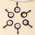 DIY jewelry charms featuring cute frying pan fried egg pendants on beige background - Black Frying Pan