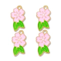 Detailed macro view of four light pink alloy cherry blossom charms with green leaves - Pink
