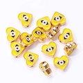 Close-up of yellow heart-shaped evil eye enamel beads for DIY jewelry making - Yellow