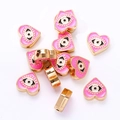 Macro shot of pink heart-shaped evil eye enamel beads for DIY jewelry making - Pink