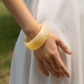Polished cream resin wide bangle bracelet with a smooth marble texture finish - Creamy Yellow Thick Bangle (AB0042-1)
