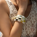 Wide chunky bracelet with gold metal blocks and white marble resin on a female wrist - Checkerboard Interlaced Wide Style (AB0034-1)