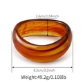 Detail view of amber resin cuff with dimensions 8.2cm diameter and 2.6cm width - Random Pattern / Tortoiseshell Brown (AB0041-2)