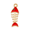 Macro detail of red fishbone charm accessory in golden alloy for DIY jewelry - Red