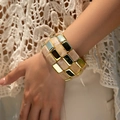 Gros plan d'un bracelet extensible avec résine marbrée beige et cubes en métal doré - AB0034-2