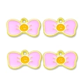 Close-up of pink enamel bow charms with yellow smiley faces for DIY jewelry making - Pink