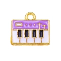 Detailed macro view of purple enamel piano key pendant made of gold-plated alloy - Purple