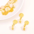 Golden Chinese Fu character pendant with white jade butterfly bead on white ceramic tray - Butterfly Blessing
