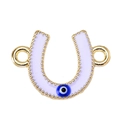 Macro detail of lavender enamel horseshoe charm with blue evil eye bead and golden finish - White