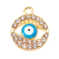 Macro shot of evil eye pendant with crystal rhinestones and blue enamel inlay finish - Blue
