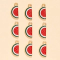 Detailed view of nine watermelon slice charms with red enamel and golden base - Watermelon Style (px0865-1)