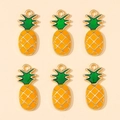 Detailed view of six yellow enamel pineapple charms with green leaves and gold borders - Pineapple Pendant (px0865-15)