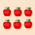 Flat lay of red enamel apple charms with green leaves and gold-plated alloy loops - Apple Shape (px0865-8)