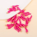 Macro shot of bright pink chili pendants with gold metal rings for DIY jewelry projects - Rose Red