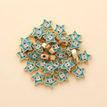 Macro detail of star-shaped evil eye beads with blue enamel and golden alloy edges - Star Shape (px0942-9)