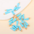 Macro shot of sky blue enamel chili pendants with gold rings for DIY jewelry making - Lake Blue