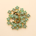 Detailed macro of star-shaped evil eye beads with green enamel and gold alloy finish - Star Shape (px0942-12)