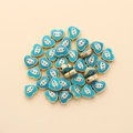 Macro view of heart-shaped evil eye beads with light blue enamel for jewelry DIY - Heart Shape (px0942-17)