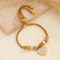 Bracciale a cuore regolabile in acciaio al titanio dorato con cristalli pavé scintillanti - Oro Cuore